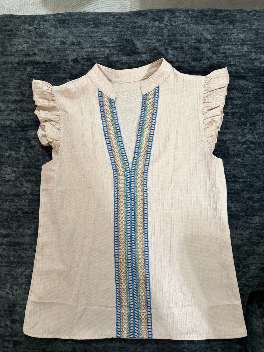 Cream Sleeveless Ruffle-Shoulder Blouse with Blue Embroidered Trim
